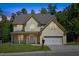 Charming two-story home featuring a two-car garage, landscaped lawn, and a welcoming front porch at 1605 Sassafras St, Durham, NC 27712