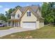 Inviting two-story home with a spacious two-car garage, a covered porch, and a well-maintained lawn at 1605 Sassafras St, Durham, NC 27712