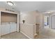 Upstairs hallway with laundry and access to multiple bedrooms at 1605 Sassafras St, Durham, NC 27712