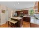 Kitchen featuring a center island, stainless steel appliances, and hardwood floors at 1605 Sassafras St, Durham, NC 27712