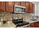 Kitchen featuring a range, stainless steel appliances, and wood cabinets at 1605 Sassafras St, Durham, NC 27712