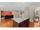A kitchen island with hardwood floors leading to an open-concept living room and kitchen at 1605 Sassafras St, Durham, NC 27712