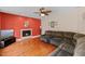 Comfortable living room with fireplace, ceiling fan, and hardwood flooring at 1605 Sassafras St, Durham, NC 27712