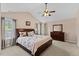Main bedroom with large bed, wood furniture, and tray ceiling with fan at 1605 Sassafras St, Durham, NC 27712