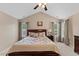 Main bedroom featuring large bed, wood furniture, and neutral decor with natural lighting at 1605 Sassafras St, Durham, NC 27712