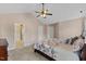 Main bedroom featuring large bed, wood furniture, vaulted ceiling with fan, and en suite bathroom at 1605 Sassafras St, Durham, NC 27712