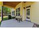 Back patio with grill, chairs, concrete and a yellow exterior at 1605 Sassafras St, Durham, NC 27712