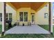 Back patio with grill, chairs, concrete and a yellow exterior at 1605 Sassafras St, Durham, NC 27712
