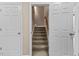 Carpeted staircase with neutral paint and access to upper level at 1605 Sassafras St, Durham, NC 27712