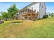 Spacious backyard featuring a multi-level deck, screened-in porch, and lush green grass at 1709 Chestnut Falls Rd, Wendell, NC 27591