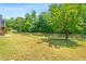 Large backyard with a well-maintained lawn, a charming garden and bordered by an elegant iron fence at 1709 Chestnut Falls Rd, Wendell, NC 27591