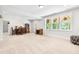Spacious basement area with carpet flooring, stained glass windows and a cozy seating arrangement at 1709 Chestnut Falls Rd, Wendell, NC 27591