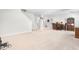 Open basement area with a staircase, carpeted flooring, and a cozy dining setup at 1709 Chestnut Falls Rd, Wendell, NC 27591
