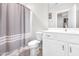 Bathroom featuring a vanity with chrome hardware, toilet and bathtub shower combo with curtain at 1709 Chestnut Falls Rd, Wendell, NC 27591