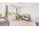 Bright bedroom featuring a crib and a large window offering ample natural light at 1709 Chestnut Falls Rd, Wendell, NC 27591
