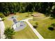 Community park featuring playground, climbing wall, and outdoor stage with lush green surroundings at 1709 Chestnut Falls Rd, Wendell, NC 27591