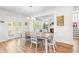 Bright dining room with wooden table, chandelier, and easy access to covered outdoor patio at 1709 Chestnut Falls Rd, Wendell, NC 27591
