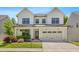 Charming two-story home featuring a classic white facade, black-framed windows, and an attached two-car garage at 1709 Chestnut Falls Rd, Wendell, NC 27591
