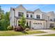 Stylish two-story home with a white exterior, complemented by well-maintained landscaping and a welcoming front porch at 1709 Chestnut Falls Rd, Wendell, NC 27591