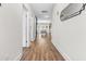 Bright hallway featuring wood floors, white walls, and modern decor, leading to a dining area at 1709 Chestnut Falls Rd, Wendell, NC 27591
