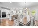 Bright, open-concept kitchen with white cabinetry, stainless steel appliances, and adjacent dining area at 1709 Chestnut Falls Rd, Wendell, NC 27591