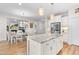 Open-concept kitchen with a center island and views of the dining area and living room, perfect for entertaining at 1709 Chestnut Falls Rd, Wendell, NC 27591