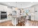 Modern kitchen featuring white cabinets, a center island with seating, and stainless steel appliances at 1709 Chestnut Falls Rd, Wendell, NC 27591