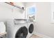 Well-lit laundry room featuring front-load washer and dryer and views out of a window at 1709 Chestnut Falls Rd, Wendell, NC 27591