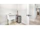 Practical laundry area with utility sink, chrome trash can, and easy access at 1709 Chestnut Falls Rd, Wendell, NC 27591