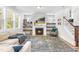 Inviting living room with fireplace, decorative shelves, plush seating, and large area rug at 1709 Chestnut Falls Rd, Wendell, NC 27591