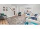 Open-concept living room featuring cozy seating, stylish area rug, and easy access to the dining area at 1709 Chestnut Falls Rd, Wendell, NC 27591