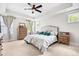 Bright main bedroom with tray ceilings, natural light, and neutral decor at 1709 Chestnut Falls Rd, Wendell, NC 27591