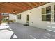 Covered outdoor patio with concrete flooring, wooden ceiling beams, and a backyard view at 1709 Chestnut Falls Rd, Wendell, NC 27591
