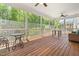 Spacious screened-in porch with wood flooring, ceiling fans, and plenty of room for outdoor seating at 1709 Chestnut Falls Rd, Wendell, NC 27591