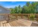 A spacious backyard wooden deck overlooks lush greenery at 1709 Chestnut Falls Rd, Wendell, NC 27591