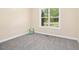 Cozy bedroom with neutral colored walls, carpeted floor and large window at 187 Old Johnson Rd, Wendell, NC 27591