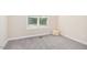 Neutral bedroom with plush carpet, a window with blinds, and a floor pillow for added comfort at 187 Old Johnson Rd, Wendell, NC 27591