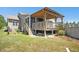 Exterior view of a home with a large deck, a screened porch, and a well-maintained lawn at 187 Old Johnson Rd, Wendell, NC 27591