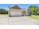 Front exterior showcasing a well-maintained two car garage, concrete driveway and manicured front lawn at 187 Old Johnson Rd, Wendell, NC 27591