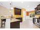 Bright kitchen features a peninsula with bar seating, granite countertops, stainless appliances and light wood flooring at 187 Old Johnson Rd, Wendell, NC 27591