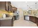 Well-appointed kitchen featuring granite countertops, stainless steel appliances, and stylish dark wood cabinetry at 187 Old Johnson Rd, Wendell, NC 27591