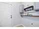 Laundry room featuring cabinets, shelving, a hanging rack, and a white door at 187 Old Johnson Rd, Wendell, NC 27591