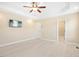 This ample main bedroom has a TV, ceiling fan, light wood floors, ensuite bath and walk in closet at 187 Old Johnson Rd, Wendell, NC 27591