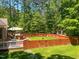 Fenced backyard featuring a lawn, wooded perimeter, and deck with outdoor seating at 19 Rivers Edge Ct, Timberlake, NC 27583
