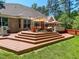 Wooden deck with seating and umbrella at 19 Rivers Edge Ct, Timberlake, NC 27583