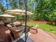 Wooden deck with seating and umbrella in backyard at 19 Rivers Edge Ct, Timberlake, NC 27583