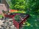 Landscaped backyard featuring a mulched garden and a brick walkway at 19 Rivers Edge Ct, Timberlake, NC 27583