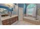 A bathroom featuring a wide vanity with a view of the bathtub and shower through the mirror at 19 Rivers Edge Ct, Timberlake, NC 27583