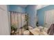 Cozy bathroom with a shower, vanity, and nature-themed curtain for a relaxing ambiance at 19 Rivers Edge Ct, Timberlake, NC 27583