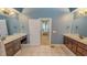 The bathroom is designed with dual sinks and a shared doorway to the main bedroom at 19 Rivers Edge Ct, Timberlake, NC 27583